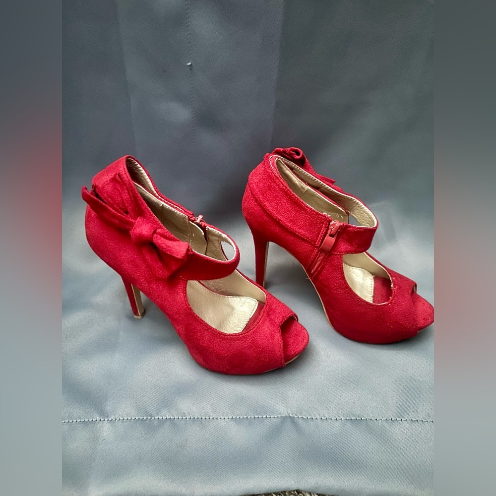 Red suede heels with side bow